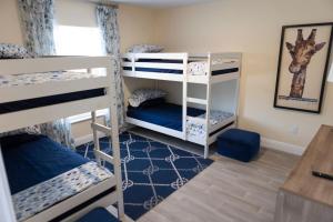 a room with three bunk beds in a room at Palm Beach Cottage in West Palm Beach