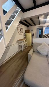a living room with a couch and a table at The Nook Devon Square in Kingsbridge