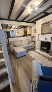 a living room with a couch and a fireplace at The Nook Devon Square in Kingsbridge