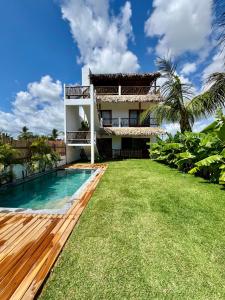 a house with a swimming pool and a yard at The Wave Kite House in Guriú