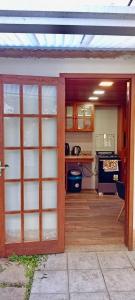a kitchen with an open door to a kitchen with a stove at Quarto suite e sala no Centro in Nova Friburgo
