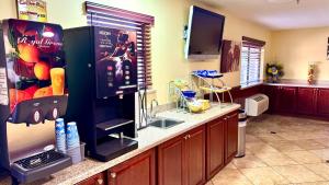 a kitchen with a refrigerator and a sink in it at Days Inn by Wyndham Rio Rancho in Rio Rancho
