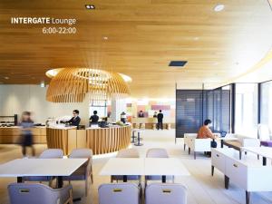 a restaurant with tables and chairs and people working at Hotel Intergate Kanazawa in Kanazawa