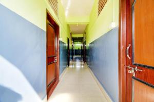 an empty hallway in a school building with a door at Hotel O NANDINI in Dibrugarh