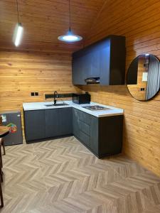 a kitchen with a sink and a counter top at اكواخ سمر in Abha +30 photos