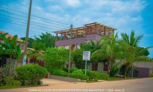 a building with a sign in front of it at Le Mia KD lodge in Sekondi-Takoradi