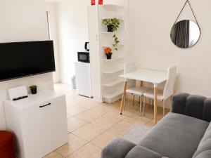 a living room with a couch and a table at Tiah Grey, Durban in Durban
