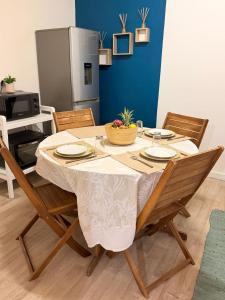 a dining room table with chairs and a tableablish at Sunshine Privilège in Deshaies