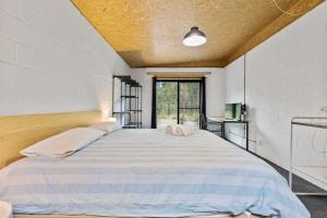 a large bed in a room with a window at Bertha's at Long Beach in Long Beach