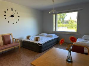 a bedroom with a bed and a clock on the wall at Private apartment in Kokkola