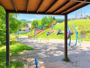 a park with a playground with a slide at Moio Homestay in Sapporo