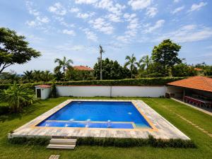 a swimming pool in the yard of a house at Villa Conejo Miraflores in Chinauta