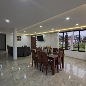 a dining room with a table and chairs at Villa Conejo Miraflores in Chinauta