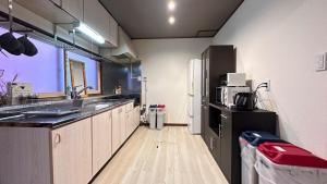 a kitchen with a sink and a refrigerator at 永山邸 in Asahikawa