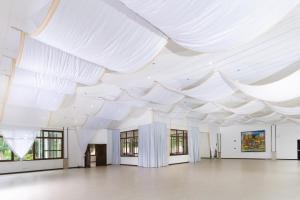 a large room with white ceilings and windows at The Glens Tagaytay in Kaybagal +44 photos
