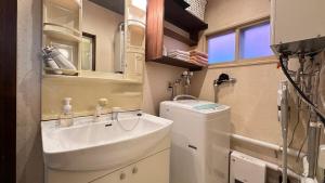 a bathroom with a sink and a washing machine at 永山邸 in Asahikawa +73 photos