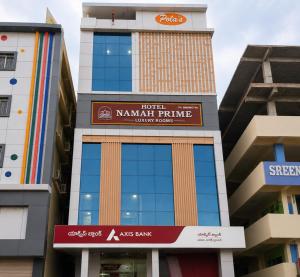 a building with a sign for a kaanett prime hotel at Hotel Namah Prime Near By Chanda Nagar Ameenpur Road in Hyderabad +7 photos