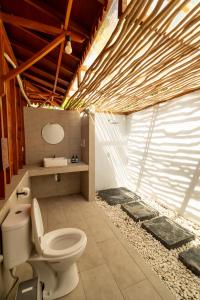 a bathroom with a toilet and a sink at Welly Bungalow in Gili Trawangan +61 photos