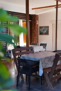 a wooden table and chairs in a room at ARBERs aparthotel in Durrës