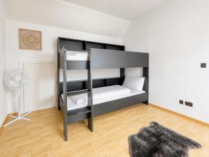 a bedroom with a bunk bed and a fan at Fewo ONE - by Europapark in Rust
