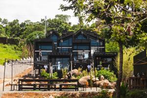 a blue house with a garden in front of it at Private Cabin for Quiet, Extended, Freescape Stays in Cavinti