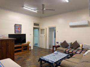 a living room with a couch and a flat screen tv at Lake Macquarie holidays in Marks Point