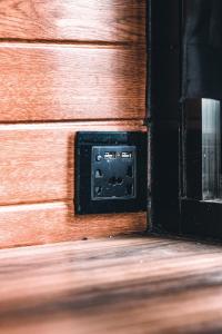 an electrical outlet on a wooden wall next to a door at Private Cabin for Quiet, Extended, Freescape Stays in Cavinti