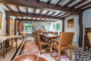 a dining room with a wooden table and chairs at Picket Post House Accommodation in Catterall