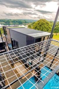 a dog laying in a cage in a swimming pool at Private Cabin for Quiet, Extended, Freescape Stays in Cavinti