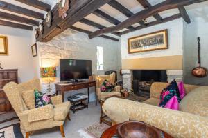 a living room with a couch and a fireplace at Picket Post House Accommodation in Catterall