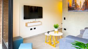 a living room with a tv on a wall at Apartamento Baruch IV in Itagüí +11 photos
