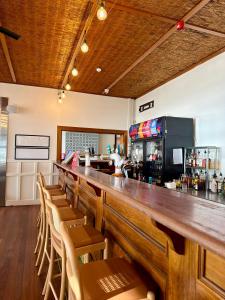 a bar with a long wooden counter and chairs at Pier Hotel Port Lincoln in Port Lincoln