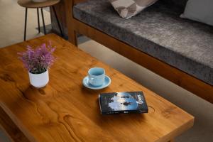 a coffee table with a book and a cup on it at Amantra Ubud in Ubud
