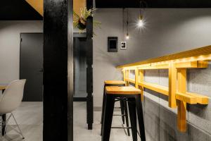 a bar with wooden stools in a room at THE GRANDEUR in Sapporo