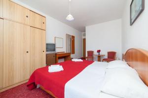 ein Schlafzimmer mit einem großen Bett mit einer roten Decke in der Unterkunft Villa Pincevic in Lopud Island
