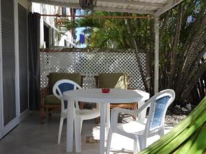 a white table and chairs on a patio at Green Garden Apartment in Christ Church