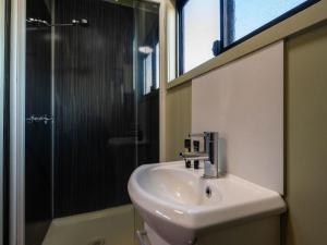 a bathroom with a sink and a shower at Longreach Tourist Park in Longreach +43 photos