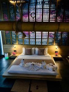 a bedroom with a large bed with towels on it at Grey Champagne Spa by Secret Apartament in Gdańsk
