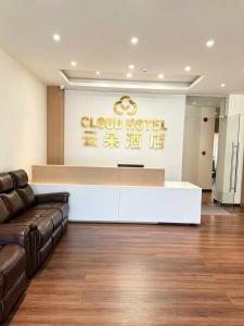 a lobby with a couch and a reception desk at The Cloud Hotel Bình Dương in Ga Phú Trung