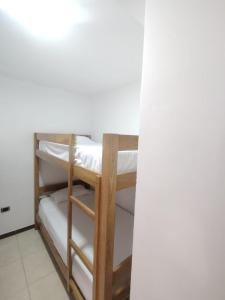a couple of bunk beds in a room at Apartamentos El paraiso cerca a Termales - cerca al centro - se aceptan mascotas in Santa Rosa de Cabal