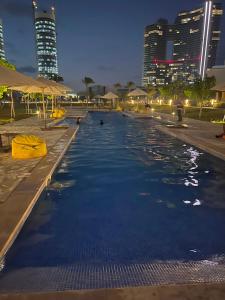 a swimming pool in a city at night at العلمين الجديدة in El Dab‘a +4 photos