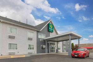 a hotel with a car parked in front of it at Quality Inn Mauston I-90 in Mauston