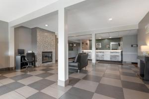 a lobby with two chairs and a fireplace at Quality Inn Mauston I-90 in Mauston