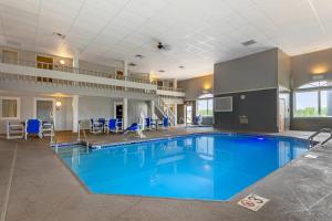 a large pool with blue water in a building at Quality Inn Mauston I-90 in Mauston
