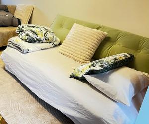 a bed with two pillows on top of a couch at Marlo Tide Retreat in Marlo