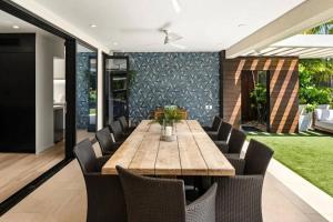 a dining room with a wooden table and chairs at Villa Kahala Honolu With Pool in Honolulu