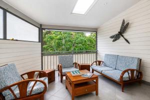 a screened in porch with chairs and a table at Dream Weaver in Bawley Point