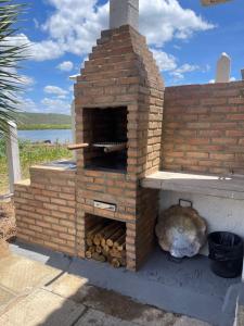 a brick oven with a turtle laying next to it at Chalé Recanto da Coruja in Pão de Açúcar