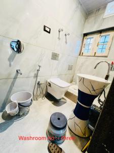 a bathroom with a toilet and a sink at Aesthetic Homestay in Harganyiwan +6 photos