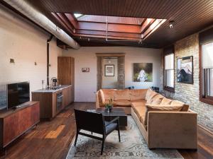 a living room with a couch and a table at Wm. Mulherin's Sons Hotel in Philadelphia